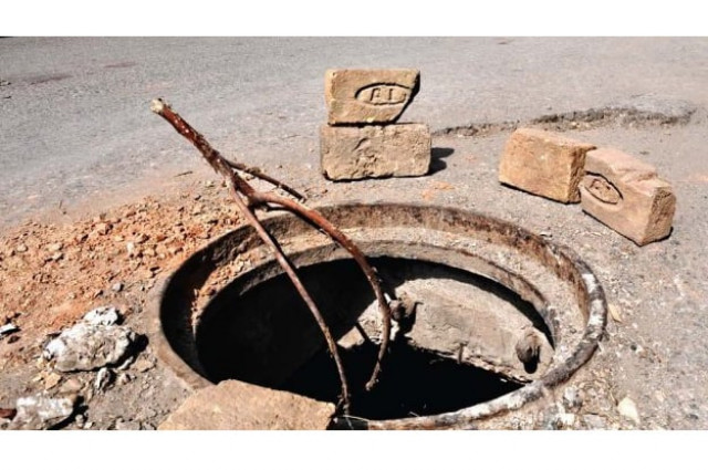 Exposed manholes put pedestrians, motorists at risk